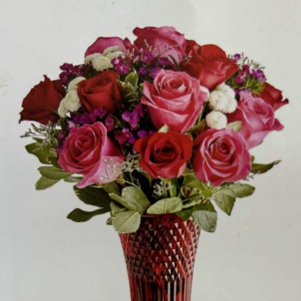 Bouquet of red and pink roses in a red cut-glass vase