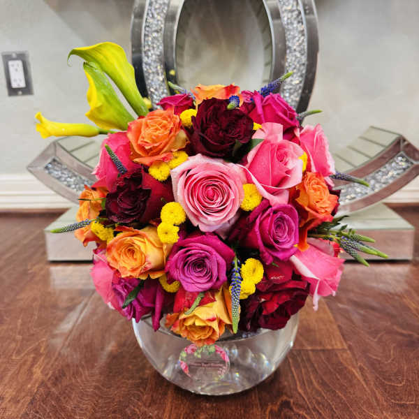 Bright mixed rose bouquet in a clear glass vase
