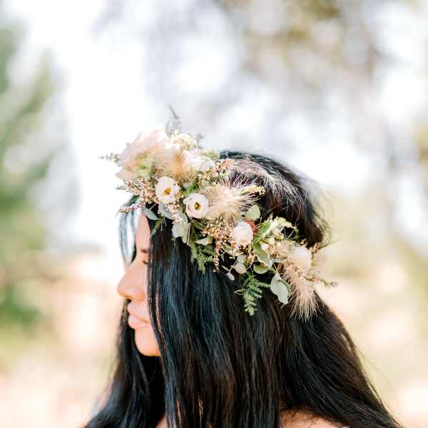 Woman wearing a floral crown with white and blush flowers