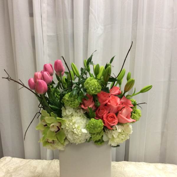 Pink tulips and roses in a white box with green accents