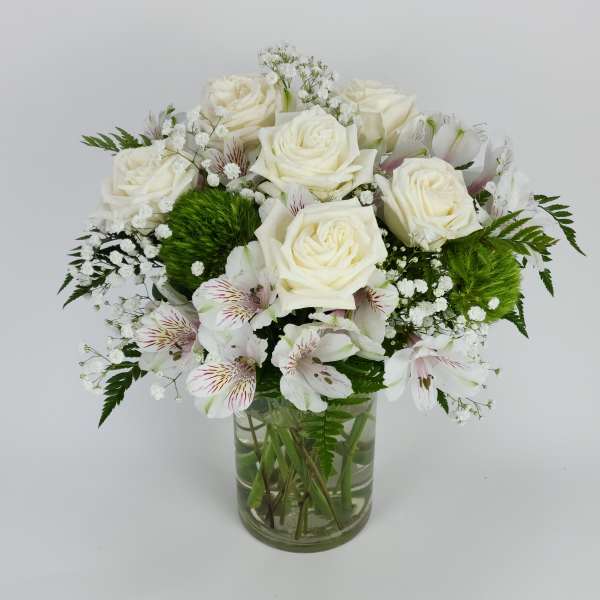 White roses and alstroemeria in a clear glass vase