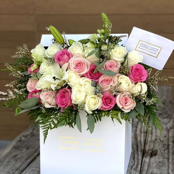 Pink and white rose bouquet in a white gift box