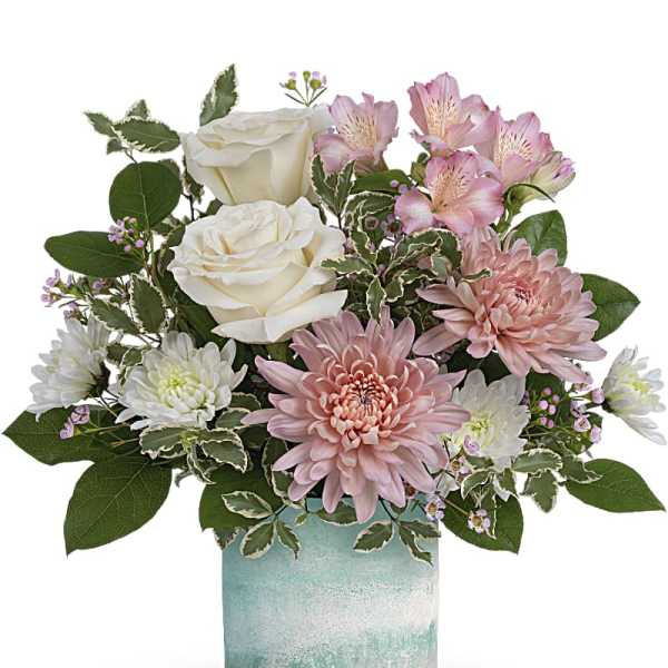 Pink and white flowers arranged in a blue glass vase