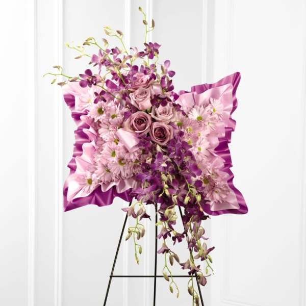 Pink and purple floral standing spray on an easel