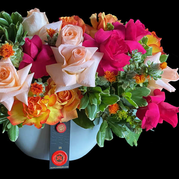 Mixed roses in a light blue hatbox-style container