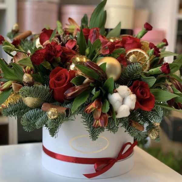 Red roses and mixed flowers in a white hat box with gold ornaments