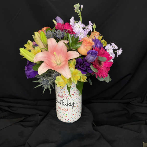 Mixed bouquet in a birthday vase with pink lily and bright gerberas