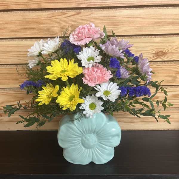Mixed bouquet in a light blue flower-shaped vase