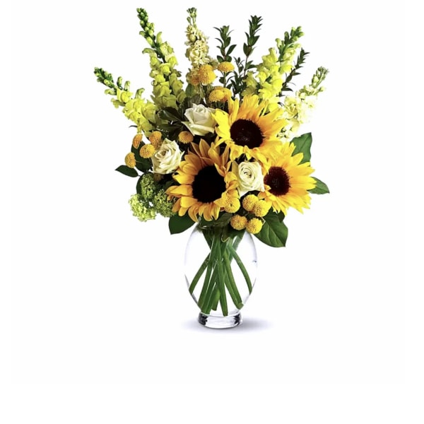 Sunflowers and white roses arranged in a clear glass vase