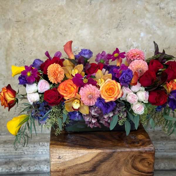 Colorful mixed flower arrangement in a low rectangular container