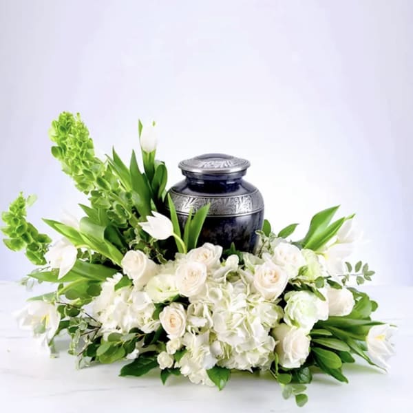 White floral arrangement with a dark urn centerpiece
