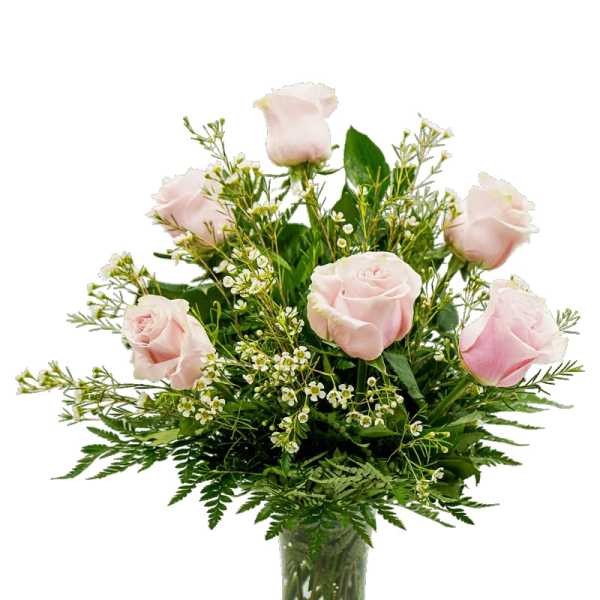 Pink roses in a glass vase with small white filler flowers