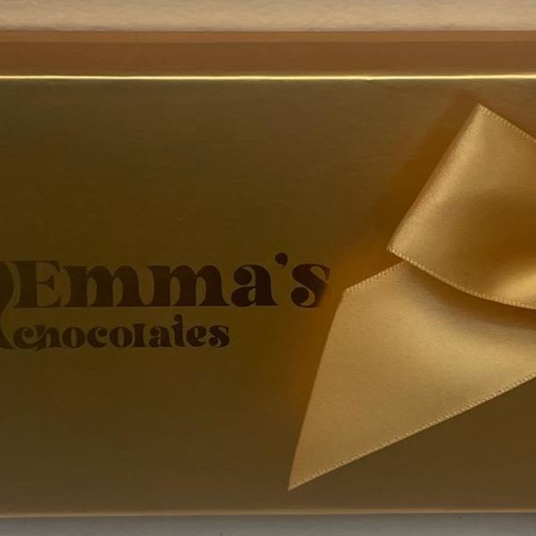 Gold gift box with a satin bow and Emma's Chocolates logo