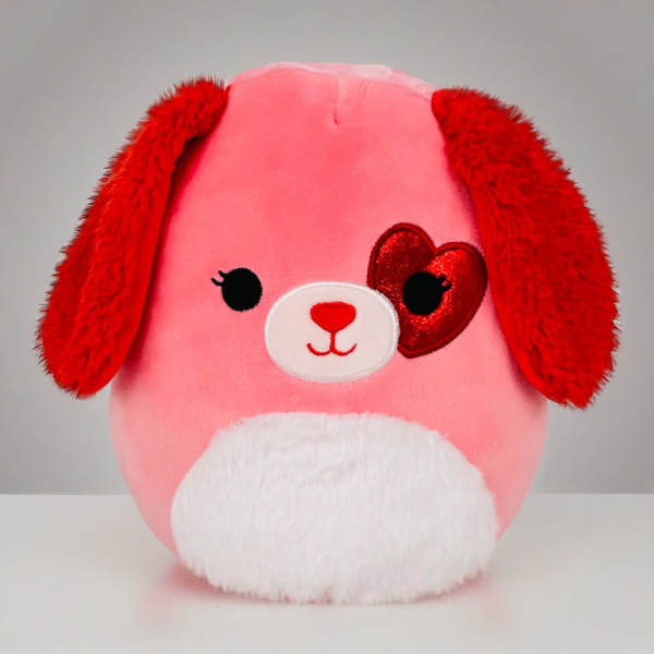 Pink and red plush puppy with floppy ears, white belly, and a red heart patch over one eye