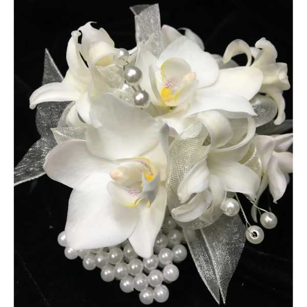 White orchid wrist corsage with silver ribbon and pearl accents on a black background