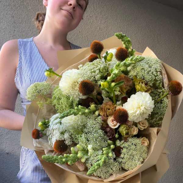 Large bouquet of white and green flowers with brown spiky blooms