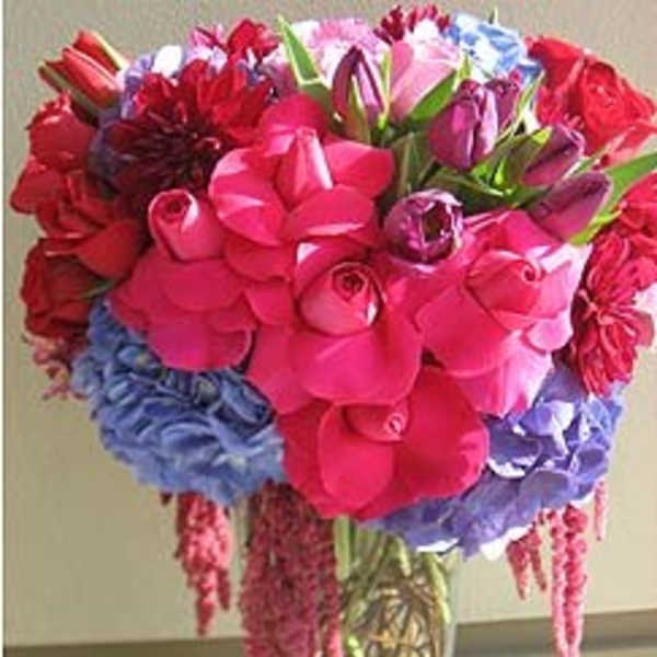 Bright mixed bouquet of roses, tulips, and hydrangeas in a vase