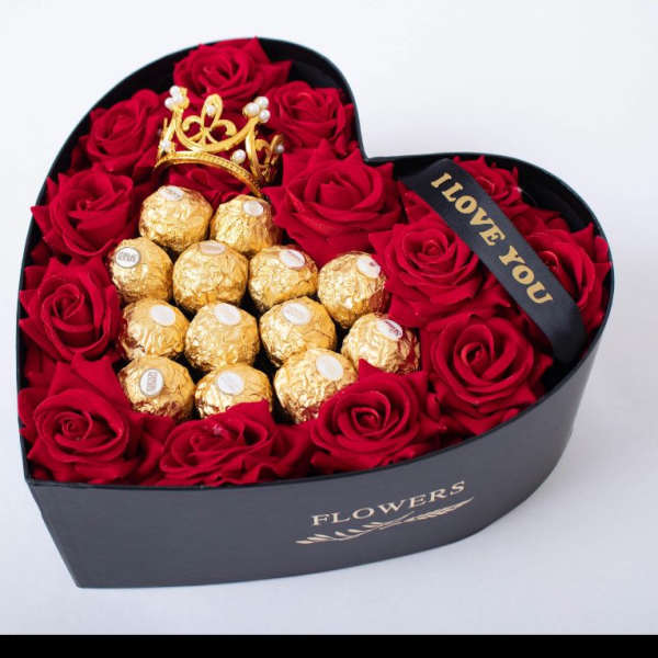 Heart-shaped box of red roses with gold-wrapped chocolates and a crown