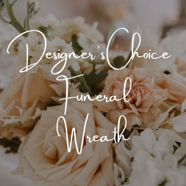 Cream and peach funeral wreath with roses and white flowers