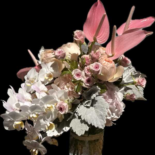 Pink and white floral arrangement in a glass vase