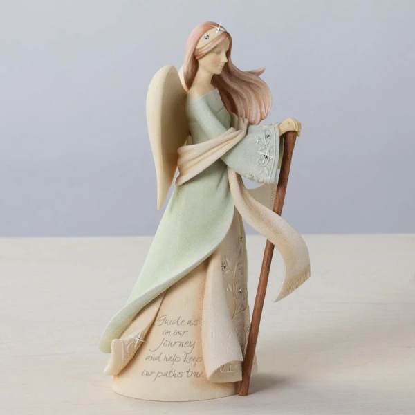 Angel figurine holding a staff, wearing a pale dress and scarf