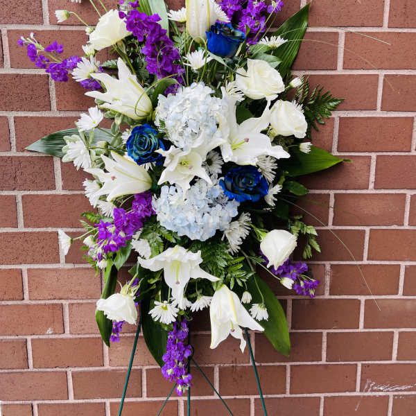 Celebrate your loved one's life with this radiant arrangement of purples and white blooms.