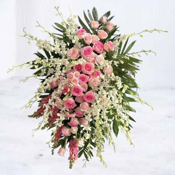 Pink roses and white orchids in a cascading floral arrangement