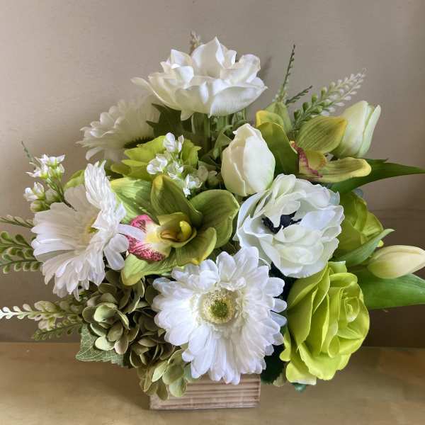 White and lime-green floral arrangement in a wooden box