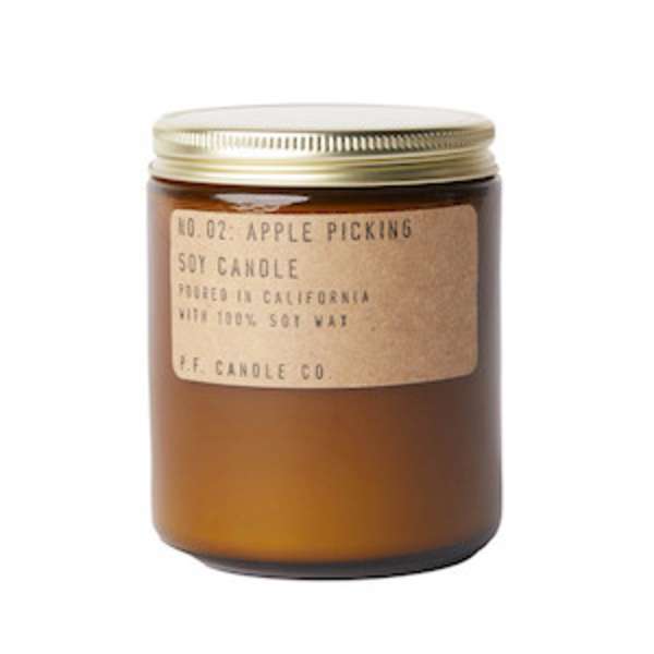 Amber jar candle with a gold lid and kraft label