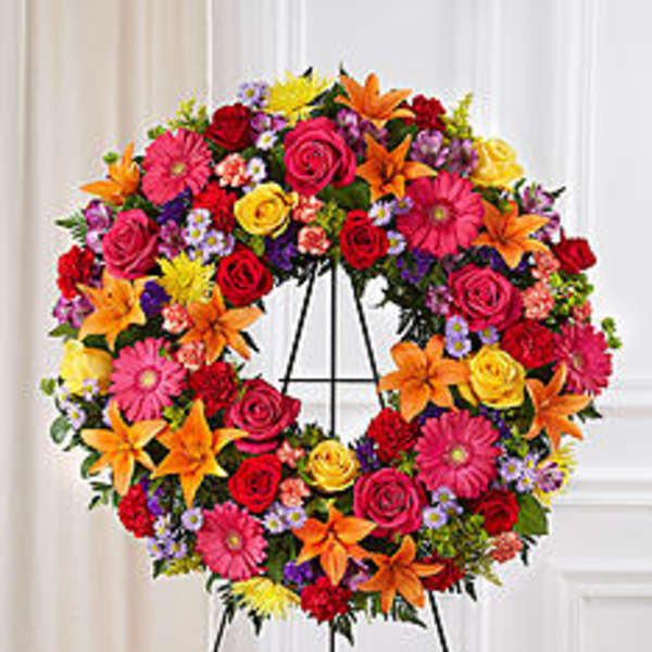 Colorful floral wreath on a black easel stand
