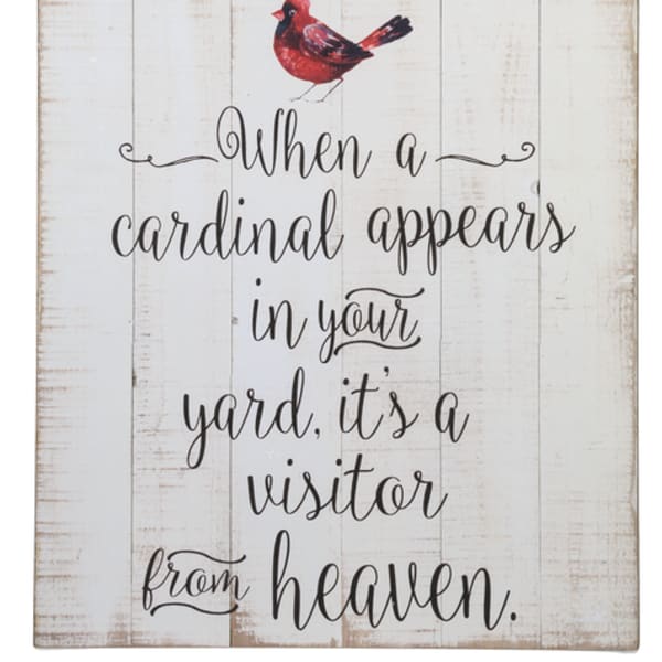 Wooden sign with a red cardinal and the phrase "When a cardinal appears in your yard, it's a visitor from heaven."