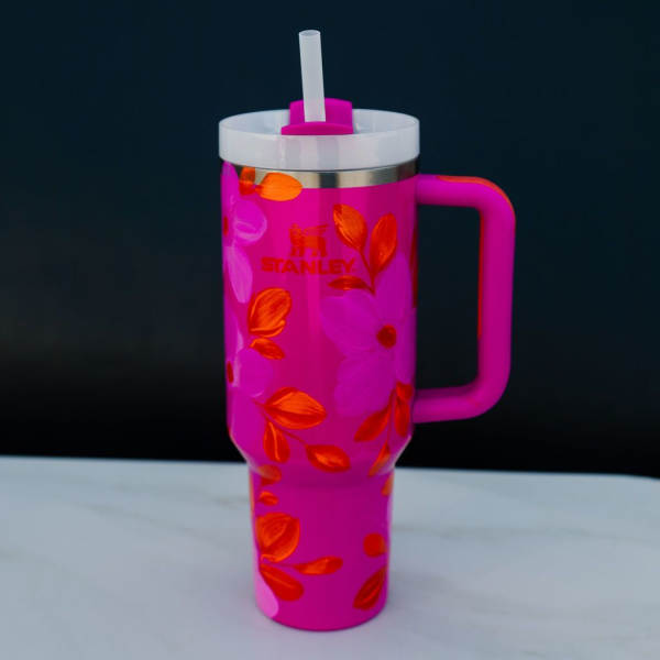 Pink Stanley tumbler with straw and floral pattern