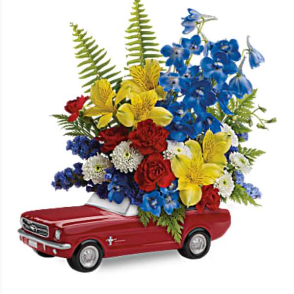 Red toy car topped with a colorful flower arrangement