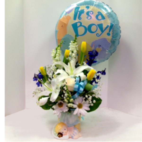 Bouquet with white lilies and daisies, topped by a blue "It's a Boy!" balloon