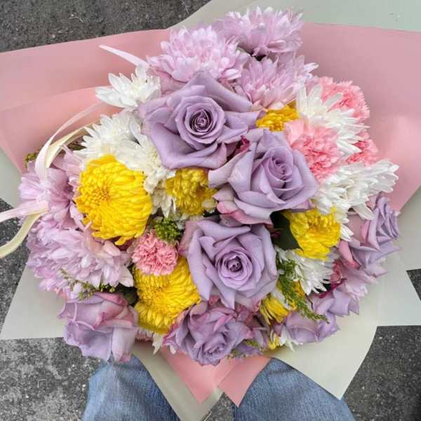 Bouquet of lavender roses, yellow chrysanthemums, and pink and white daisies