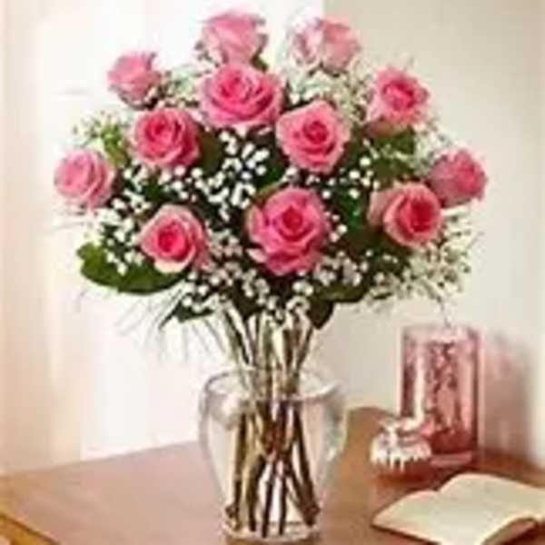 Pink roses arranged in a clear glass vase