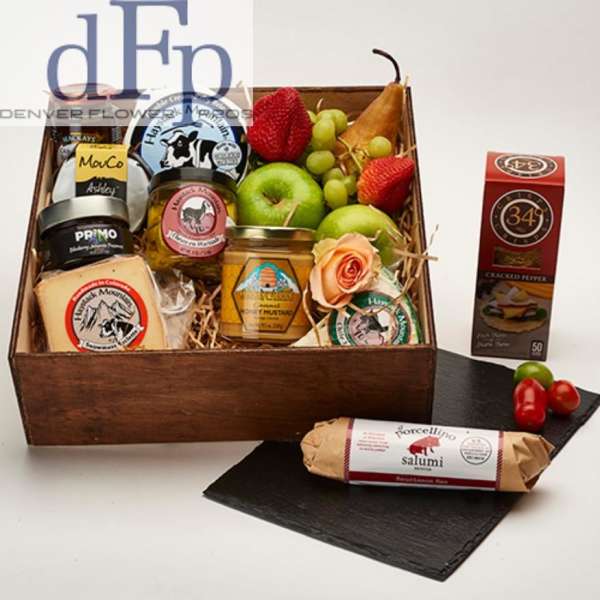 Gift basket with fruit, cheese, jam, and a peach rose