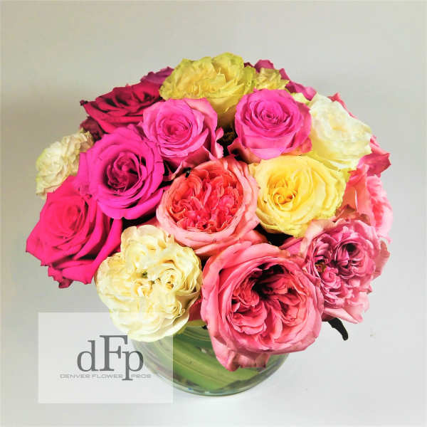 Bouquet of multicolored roses in a clear glass vase