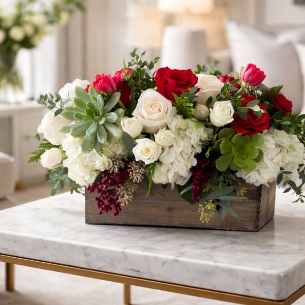 Arrangement of red and white roses in a wooden box
