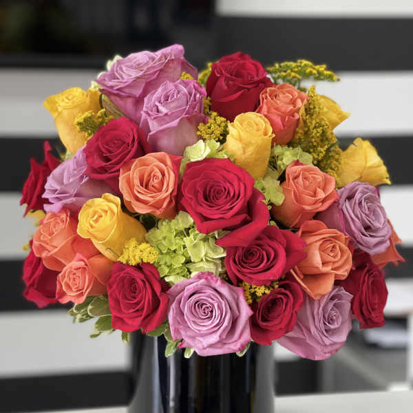 Bouquet of multicolored roses in a black vase