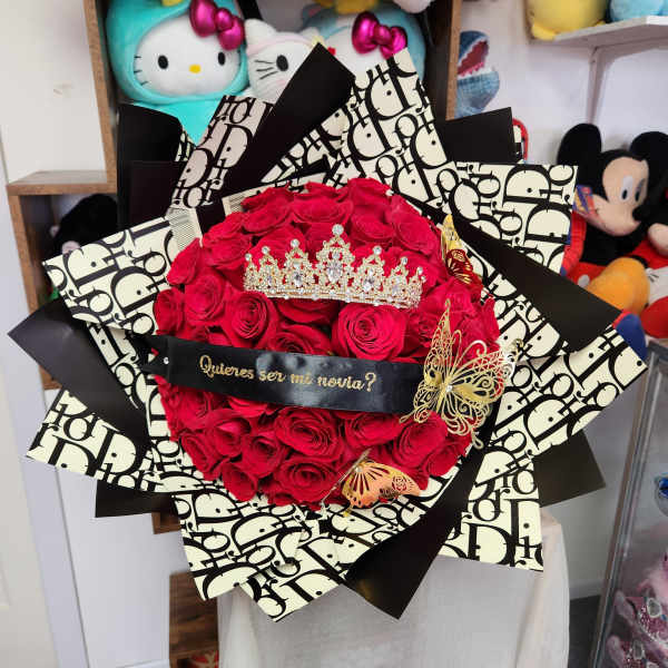 Bouquet of red roses with a jeweled crown and black patterned wrap