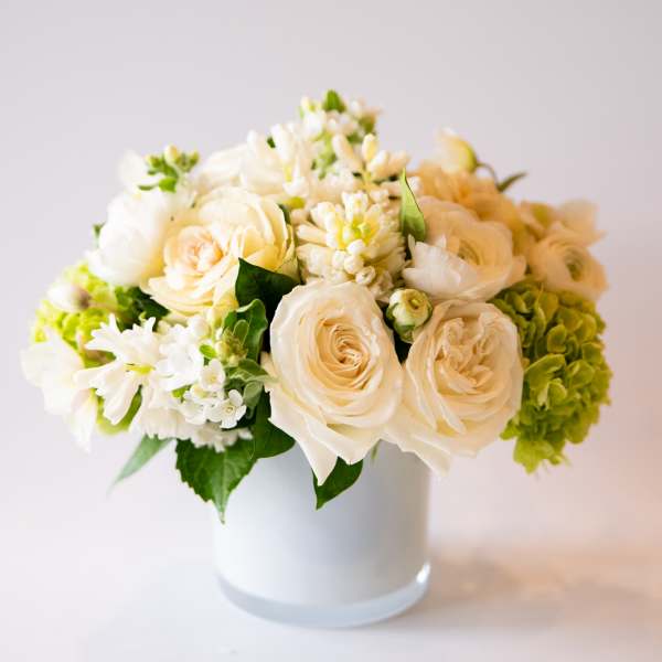 Cream and white flower arrangement in a white vase