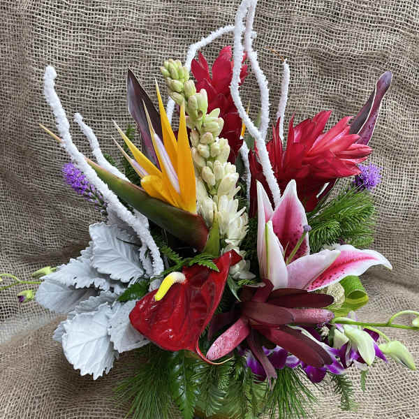 Tropical bouquet with red and pink flowers in a vase