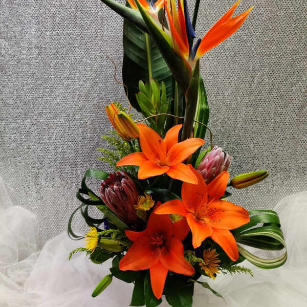 Tall tropical bouquet with orange lilies and bird of paradise