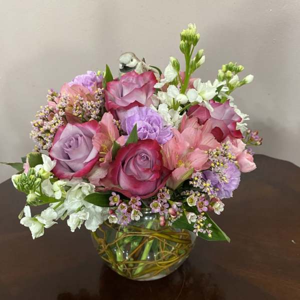 Pink and lavender rose bouquet in a glass vase