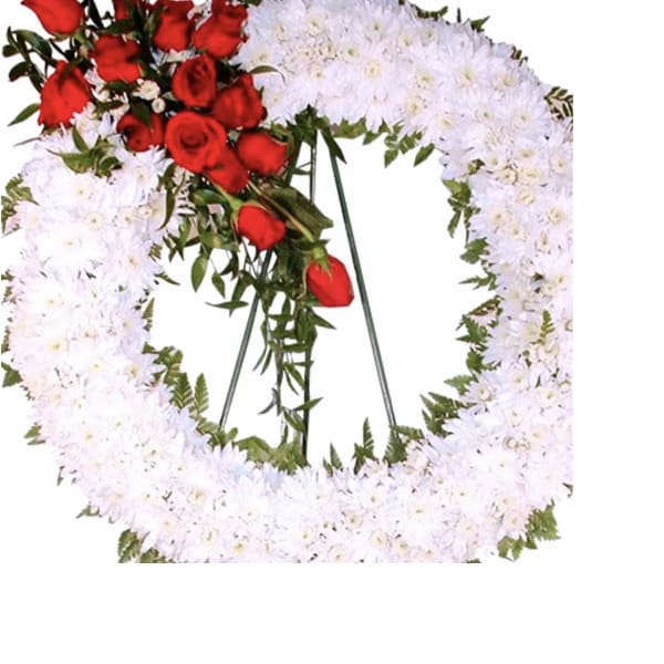 Red roses and white flowers arranged in a heart-shaped wreath