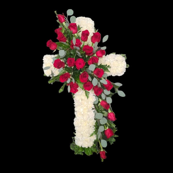 Cross-shaped floral tribute with red roses and white flowers