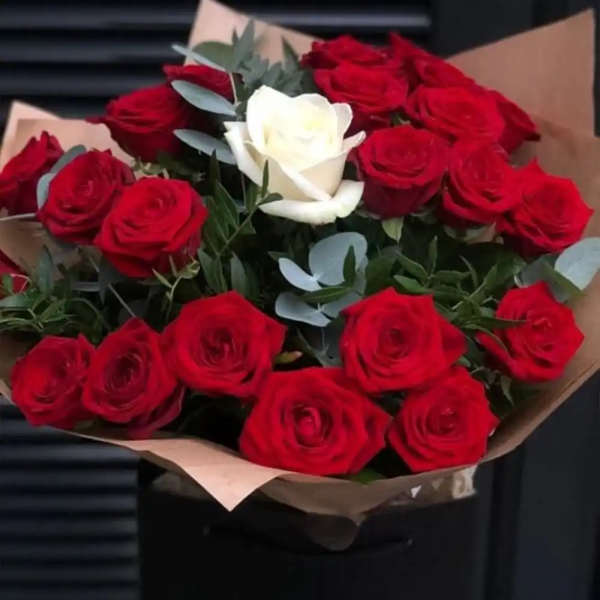 Bouquet of red and white roses wrapped in brown paper