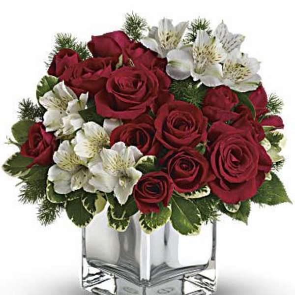 Red roses and white alstroemeria in a clear square vase