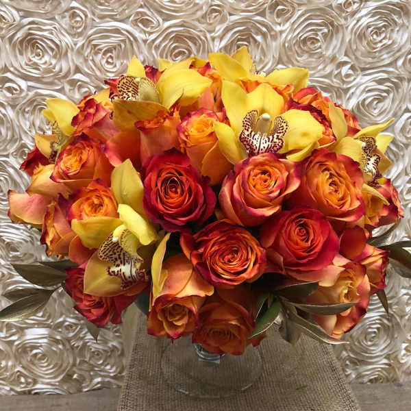 Bouquet of orange and red roses with yellow orchids